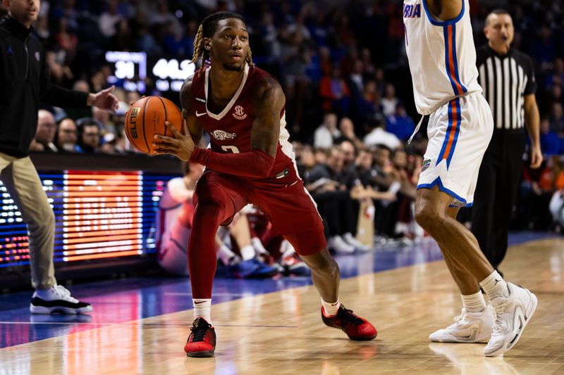 Jan 13, 2024; Gainesville, Florida, USA; Arkansas Razorbacks guard El Ellis (3) controls the ball against Florida Gators guard Zyon Pullin (0) during the first half at Exactech Arena at the Stephen C. O'Connell Center. Mandatory Credit: Matt Pendleton-USA TODAY Sports