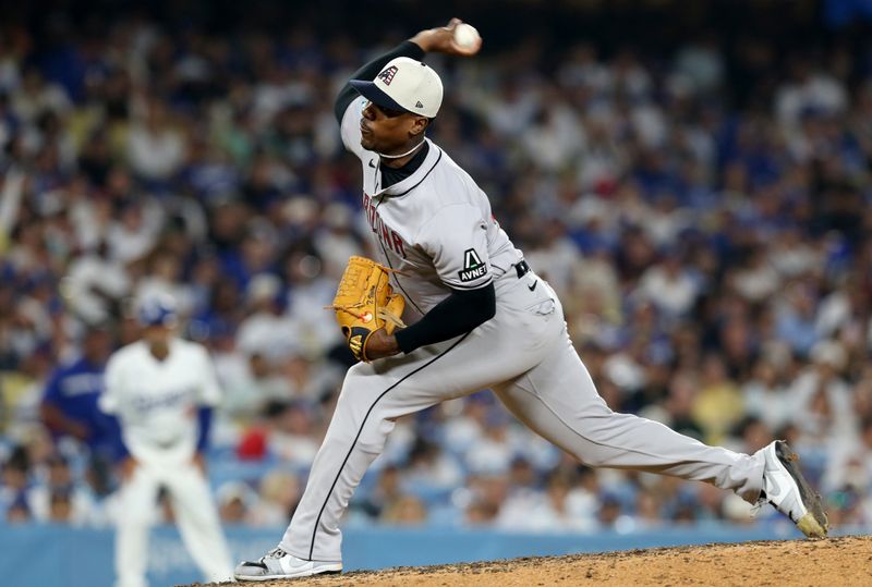 Jul 4, 2024; Los Angeles, California, USA; Arizona Diamondbacks pitcher Thyago Vieira (49) throws during the ninth inning against the Los Angeles Dodgers at Dodger Stadium. Mandatory Credit: Jason Parkhurst-USA TODAY Sports