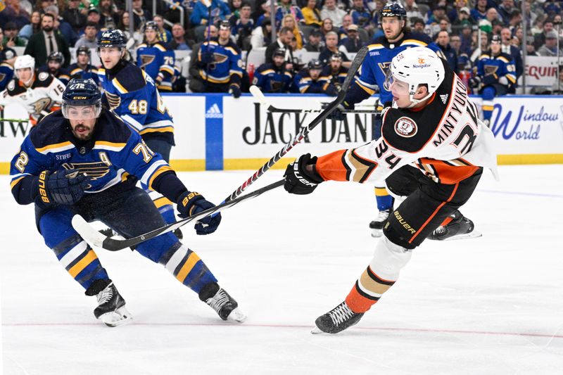 Mar 17, 2024; St. Louis, Missouri, USA; St. Louis Blues defenseman Justin Faulk (72) defends a shot from Anaheim Ducks defenseman Pavel Mintyukov (34) during the first period at Enterprise Center. Mandatory Credit: Jeff Le-USA TODAY Sports