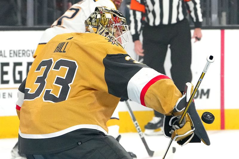 Feb 20, 2024; Las Vegas, Nevada, USA; Vegas Golden Knights goaltender Adin Hill (33) makes a blocker save against the Nashville Predators during the first period at T-Mobile Arena. Mandatory Credit: Stephen R. Sylvanie-USA TODAY Sports