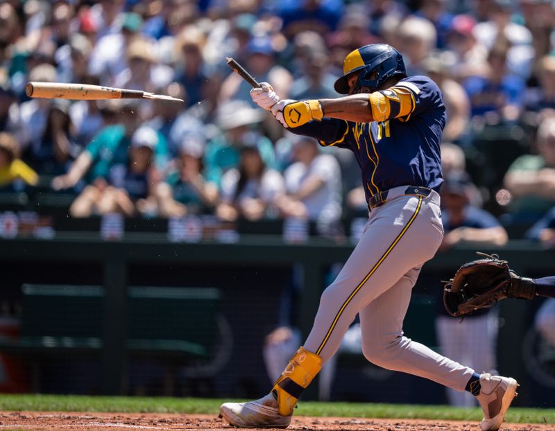 Jul 23, 2025; Seattle, Washington, USA;  Milwaukee Brewers right fielder Jackson Chourio (11) breaks his bat during the third inning against the Seattle Mariners at T-Mobile Park. Mandatory Credit: Stephen Brashear-Imagn Images