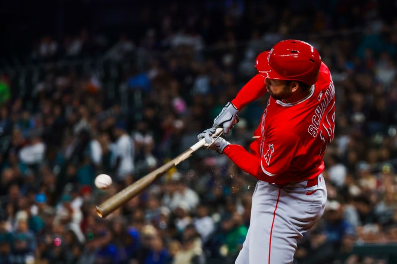 Apr 29, 2025; Seattle, Washington, USA; Los Angeles Angels first baseman Nolan Schanuel (18) breaks his bat while grounding into a double play against the Seattle Mariners to end the third inning at T-Mobile Park. Mandatory Credit: Joe Nicholson-Imagn Images