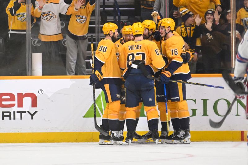 Dec 21, 2025; Nashville, Tennessee, USA;  Nashville Predators left wing Filip Forsberg (9) celebrates with his teammates after scoring a goal against the New York Rangers during the second period at Bridgestone Arena. Mandatory Credit: Steve Roberts-Imagn Images