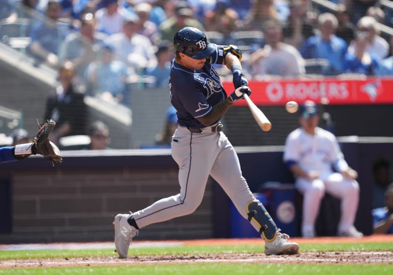 May 18, 2024; Toronto, Ontario, CAN; Tampa Bay Rays right fielder Jonny DeLuca (21) gets on first base on a fielders choice during the fourth inning against the Toronto Blue Jays at Rogers Centre. Mandatory Credit: Nick Turchiaro-USA TODAY Sports