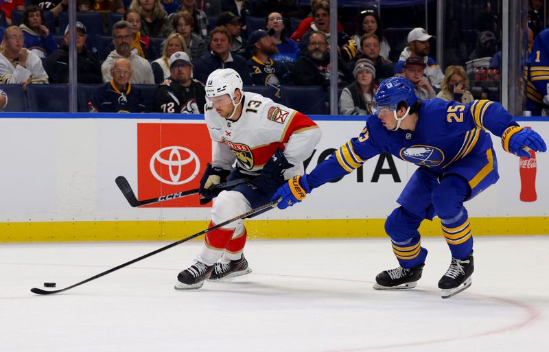 Oct 12, 2024; Buffalo, New York, USA;  Buffalo Sabres defenseman Owen Power (25) knocks the puck off the stick of Florida Panthers center Sam Reinhart (13) during the first period at KeyBank Center. Mandatory Credit: Timothy T. Ludwig-Imagn Images