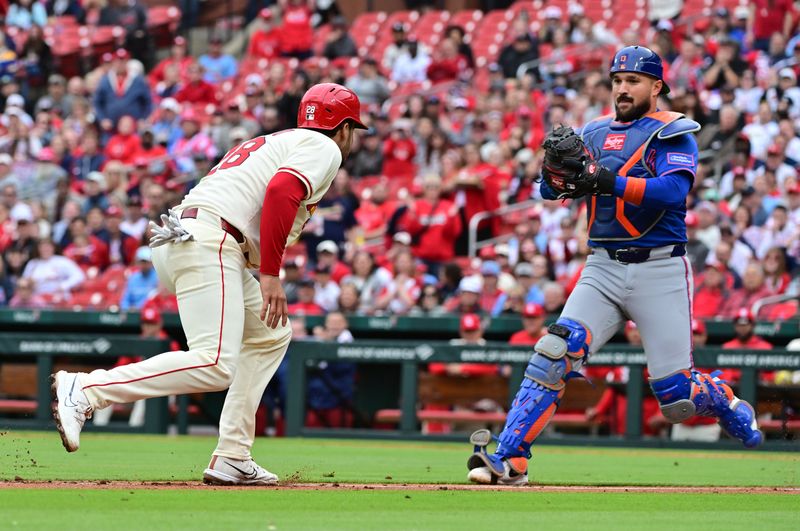 May 4, 2025; St. Louis, Missouri, USA; St. Louis Cardinals third baseman Nolan Arenado (28, left) is caught in a rundown between third and home and is eventually tagged out by New York Mets catcher Luis Torrens (13) at Busch Stadium. Mandatory Credit: Tim Vizer-Imagn Images
