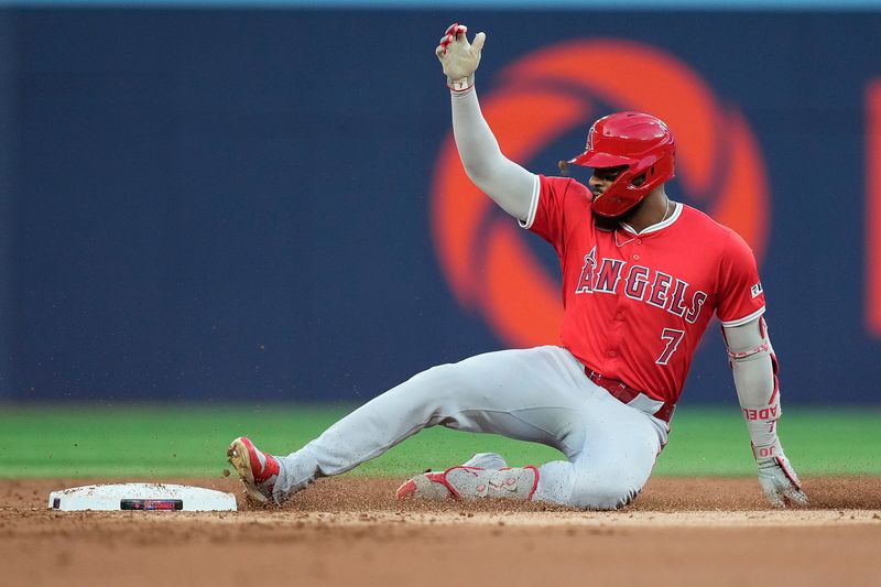 Aug 23, 2024; Toronto, Ontario, CAN; Los Angeles Angels right fielder Jo Adell (7) slides into second on his one run double against the Toronto Blue Jays during the second inning at Rogers Centre. Mandatory Credit: John E. Sokolowski-USA TODAY Sports