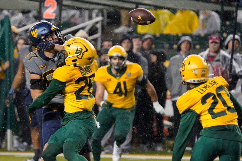 Nov 25, 2023; Waco, Texas, USA; Baylor Bears safety Devyn Bobby (28) breaks up the pass to West Virginia Mountaineers tight end Kole Taylor (87) during the first half at McLane Stadium. Mandatory Credit: Raymond Carlin III-USA TODAY Sports