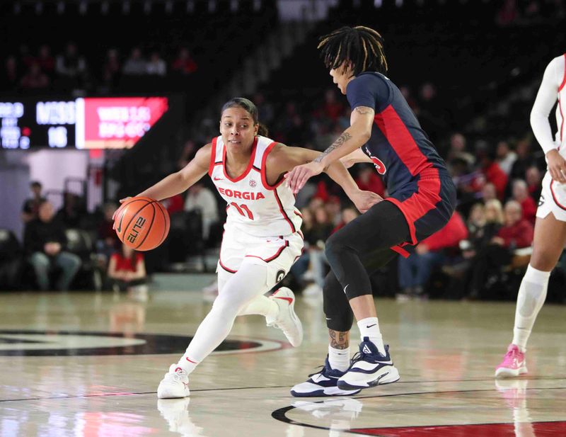 Jan 21, 2024; Athens, Georgia, USA; Georgia guard Asia Avinger (11) dribbles against Ole Miss Rebels forward Snudda Collins (5) during the second half at Stegeman Coliseum. Mandatory Credit: Mady Mertens-USA TODAY Sports