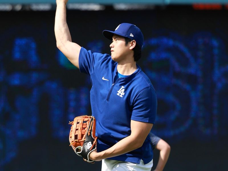 May 3, 2024; Los Angeles, California, USA;  Los Angeles Dodgers two-way player Shohei Ohtani (17) plays a catch before the game against the Atlanta Braves at Dodger Stadium. Mandatory Credit: Kiyoshi Mio-USA TODAY Sports