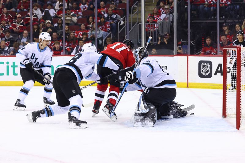 Oct 14, 2024; Newark, New Jersey, USA; New Jersey Devils right wing Stefan Noesen (11) scores a goal on Utah Hockey Club goaltender Karel Vejmelka (70) during the second period at Prudential Center. Mandatory Credit: Ed Mulholland-Imagn Images