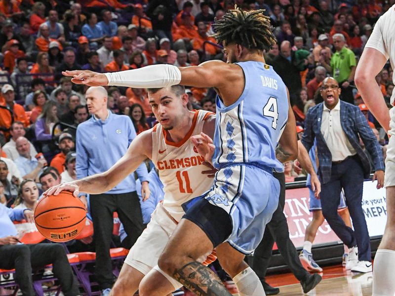 Jan 6, 2024; Clemson, South Carolina, USA; Clemson graduate Joseph Girard III  dribbles defended by University of North Carolina guard RJ Davis (4) during the first half at Littlejohn Coliseum. Mandatory Credit: Ken Ruinard-USA TODAY Sports