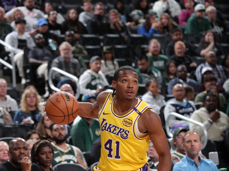 MILWAUKEE, WI - OCTOBER 10: Quincy Olivari #41 of the Los Angeles Lakers dribbles the ball during the game against the Milwaukee Bucks during a preseason game on October 10, 2024 at Fiserv Forum Center in Milwaukee, Wisconsin. NOTE TO USER: User expressly acknowledges and agrees that, by downloading and or using this Photograph, user is consenting to the terms and conditions of the Getty Images License Agreement. Mandatory Copyright Notice: Copyright 2024 NBAE (Photo by Gary Dineen/NBAE via Getty Images).