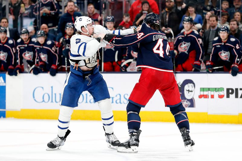 Dec 29, 2023; Columbus, Ohio, USA; Columbus Blue Jackets defenseman Erik Gudbranson (44) and Toronto Maple Leafs defenseman Simon Benoit (2) fight during the second period at Nationwide Arena. Mandatory Credit: Russell LaBounty-USA TODAY Sports