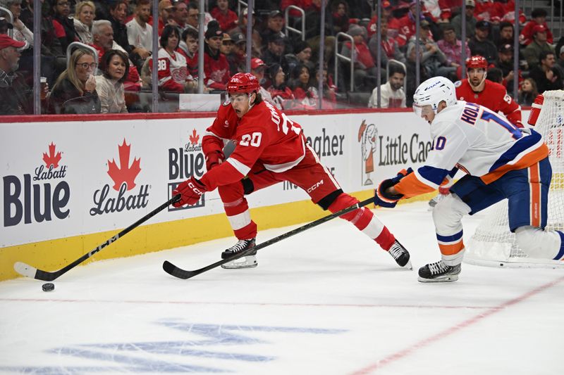 Nov 21, 2024; Detroit, Michigan, USA;  Detroit Red Wings defenseman Albert Johansson (20) chases down the puck behind the Red Wing goal ahead of New York Islanders right wing Simon Holmstrom (10) in the first period at Little Caesars Arena. Mandatory Credit: Lon Horwedel-Imagn Images