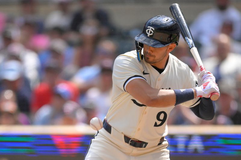 Jul 24, 2024; Minneapolis, Minnesota, USA;  Minnesota Twins designated hitter Trevor Larnach (9) is hit by a pitch against the Philadelphia Phillies during the ninth inning at Target Field. Mandatory Credit: Nick Wosika-USA TODAY Sports