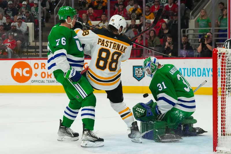 Mar 26, 2023; Raleigh, North Carolina, USA;  Carolina Hurricanes goaltender Frederik Andersen (31) and  defenseman Brady Skjei (76) stops the scoring attempt by Boston Bruins right wing David Pastrnak (88) in the over time at PNC Arena. Mandatory Credit: James Guillory-USA TODAY Sports