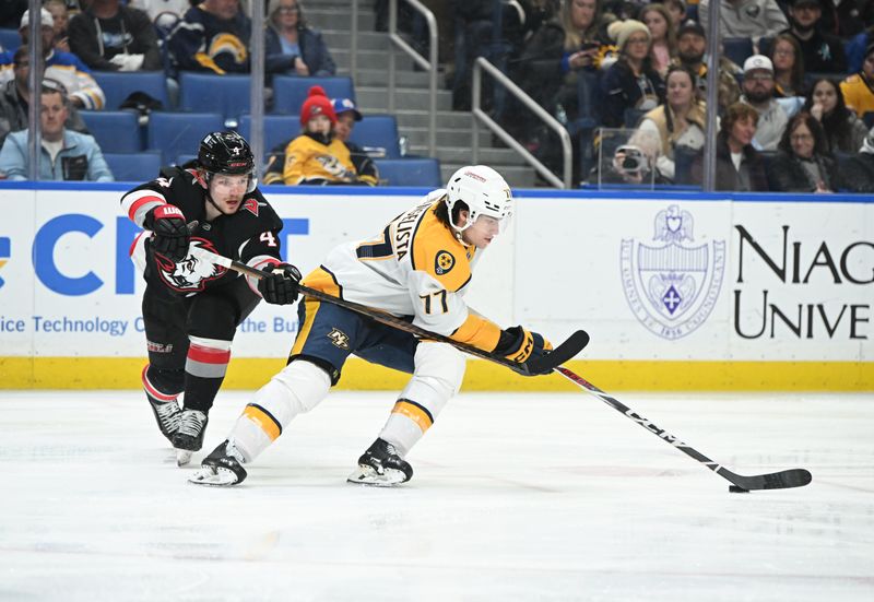 Jan 31, 2025; Buffalo, New York, USA; Nashville Predators right wing Luke Evangelista (77) skates with the puck in front of Buffalo Sabres defenseman Bowen Byram (4) in the third period at the KeyBank Center. Mandatory Credit: Mark Konezny-Imagn Images