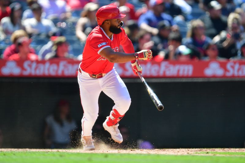 May 26, 2024; Anaheim, California, USA; Los Angeles Angels second base Luis Rengifo (2) hits an RBI single against the Cleveland Guardians during the eighth inning at Angel Stadium. Mandatory Credit: Gary A. Vasquez-USA TODAY Sports