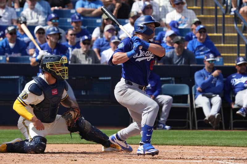 Mar 9, 2026; Phoenix, Arizona, USA; Los Angeles Dodgers catcher Dalton Rushing (68) hits an RBI single against the Milwaukee Brewers in the third inning at American Family Fields of Phoenix. Mandatory Credit: Rick Scuteri-Imagn Images
