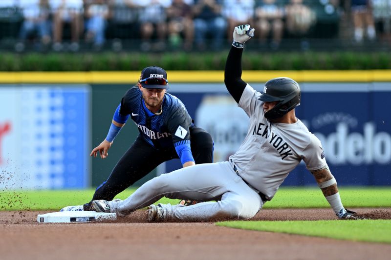 Aug 16, 2024; Detroit, Michigan, USA;  New York Yankees second baseman Gleyber Torres (25) slides safely into second base ahead of the tag from Detroit Tigers second baseman Zach McKinstry (39) after Tigers center fielder Parker Meadows (not pictured) misplayed Torres’ single in the first inning at Comerica Park. Mandatory Credit: Lon Horwedel-USA TODAY Sports