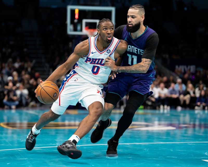 CHARLOTTE, NORTH CAROLINA - DECEMBER 03: Cody Martin #11 of the Charlotte Hornets guards Tyrese Maxey #0 of the Philadelphia 76ers in the fourth quarter of the game during the Emirates NBA Cup at Spectrum Center on December 03, 2024 in Charlotte, North Carolina. NOTE TO USER: User expressly acknowledges and agrees that, by downloading and or using this photograph, User is consenting to the terms and conditions of the Getty Images License Agreement. (Photo by Jacob Kupferman/Getty Images)