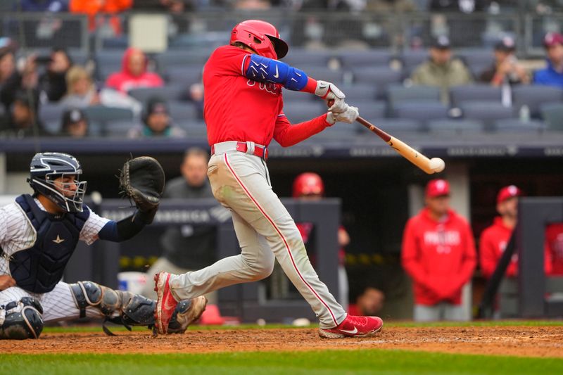 Apr 5, 2023; Bronx, New York, USA; Philadelphia Phillies second baseman Bryson Stott (5) hits a single against the New York Yankees during the seventh inning at Yankee Stadium. Mandatory Credit: Gregory Fisher-USA TODAY Sports