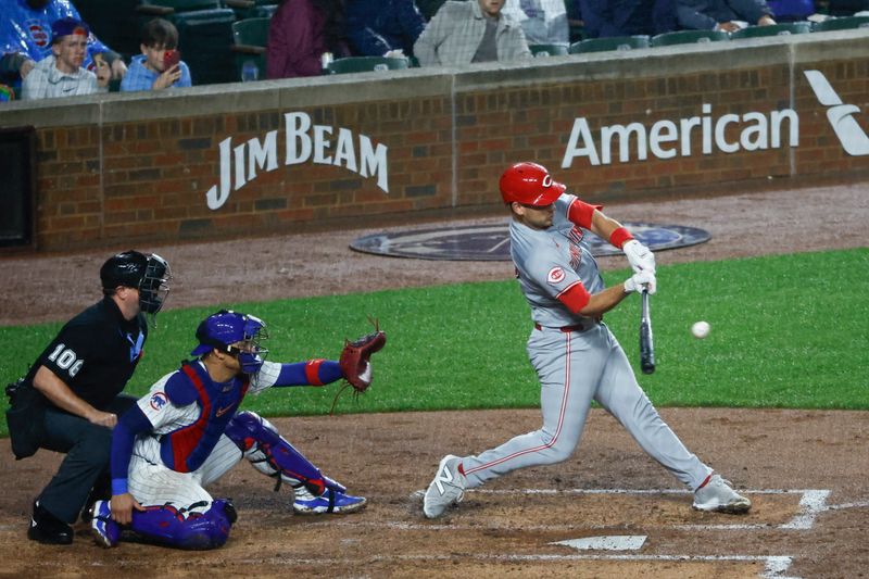 Jun 1, 2024; Chicago, Illinois, USA; Cincinnati Reds catcher Luke Maile (22) reaches on the fielding error by Chicago Cubs outfielder Seiya Suzuki during the second inning at Wrigley Field. Mandatory Credit: Kamil Krzaczynski-USA TODAY Sports