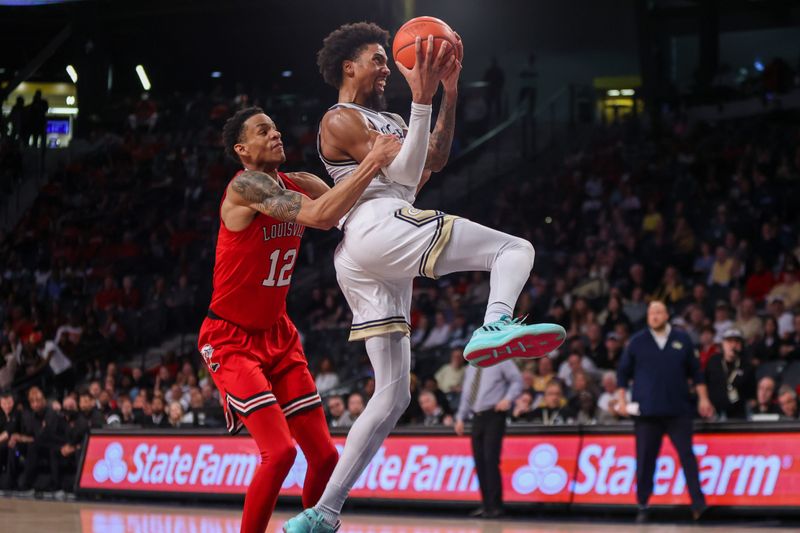 Feb 25, 2023; Atlanta, Georgia, USA; Louisville Cardinals forward JJ Traynor (12) fouls Georgia Tech Yellow Jackets forward Javon Franklin (4) in the second half at McCamish Pavilion. Mandatory Credit: Brett Davis-USA TODAY Sports