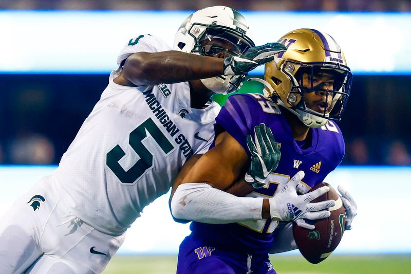 Sep 17, 2022; Seattle, Washington, USA; Washington Huskies safety Julius Irvin (29) intercepts a pass intended for Michigan State Spartans wide receiver Germine Bernard (5) during the fourth quarter at Alaska Airlines Field at Husky Stadium. Mandatory Credit: Joe Nicholson-USA TODAY Sports