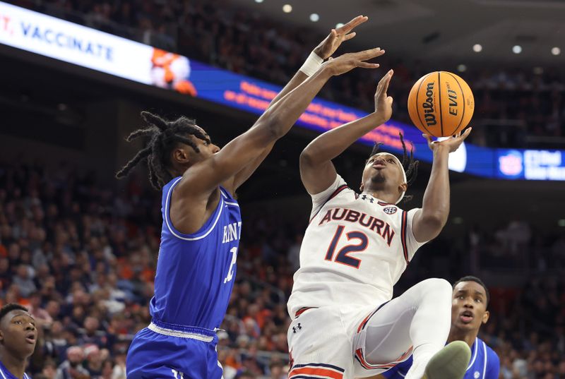 Feb 17, 2024; Auburn, Alabama, USA; Auburn Tigers Denver Jones (12) takes a shot against Kentucky Wildcats guard Antonio Reeves (12) during the second half at Neville Arena. Mandatory Credit: John Reed-USA TODAY Sports