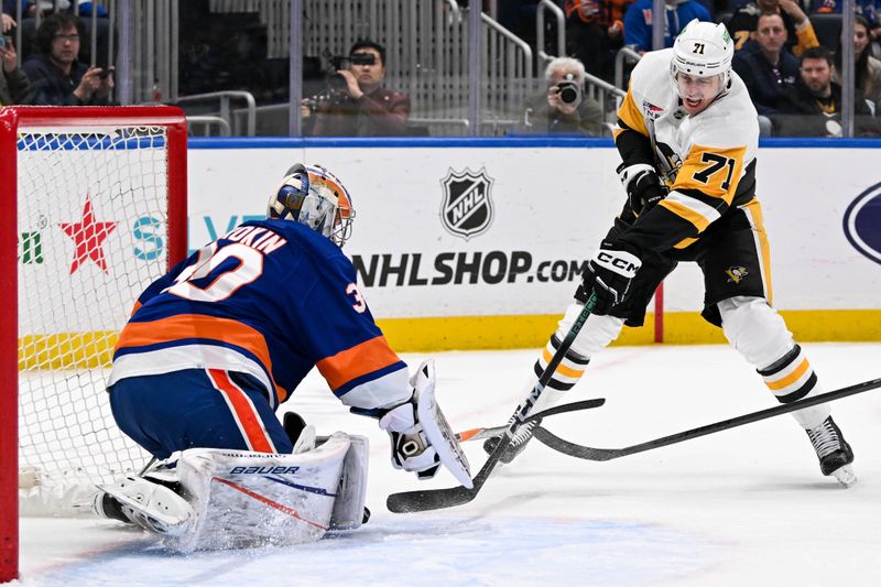 Apr 17, 2024; Elmont, New York, USA;  New York Islanders goaltender Ilya Sorokin (30) makes a save Pittsburgh Penguins center Evgeni Malkin (71) during the first period at UBS Arena. Mandatory Credit: Dennis Schneidler-USA TODAY Sports