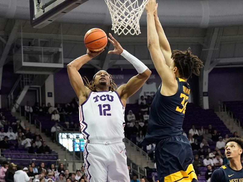 Jan 31, 2023; Fort Worth, Texas, USA; TCU Horned Frogs forward Xavier Cork (12) dunks the ball against West Virginia Mountaineers forward James Okonkwo (32) during the first half at Ed and Rae Schollmaier Arena. Mandatory Credit: Chris Jones-USA TODAY Sports