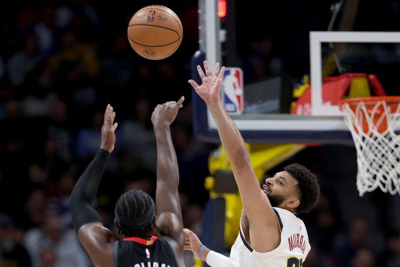 DENVER, COLORADO - NOVEMBER 29: Jamal Murray #27 of the Denver Nuggets attempts to block the shot of Aaron Holiday #0 of the Houston Rockets in the first quarter at Ball Arena on November 29, 2023 in Denver, Colorado. NOTE TO USER: User expressly acknowledges and agrees that, by downloading and or using this photograph, User is consenting to the terms and conditions of the Getty Images License Agreement. (Photo by Matthew Stockman/Getty Images)