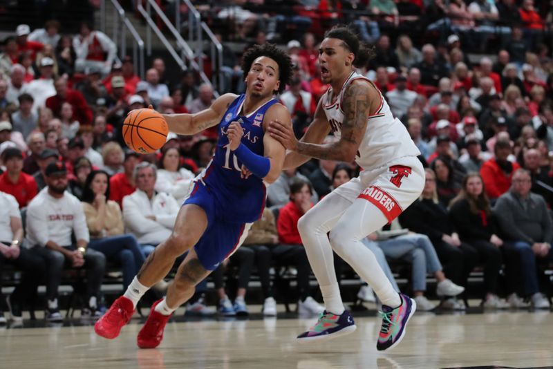 Jan 3, 2023; Lubbock, Texas, USA;  Kansas Jayhawks forward Jalen Wilson (10) drives the ball around Texas Tech Red Raiders guard Jaylon Tyson (20) in the second half at United Supermarkets Arena. Mandatory Credit: Michael C. Johnson-USA TODAY Sports