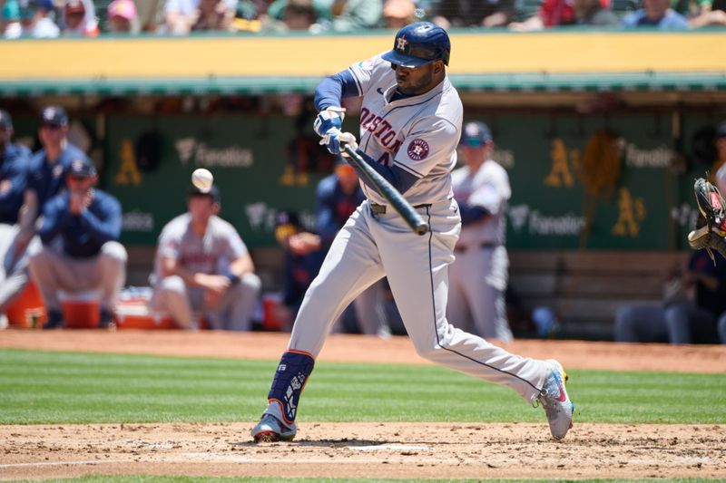 May 26, 2024; Oakland, California, USA; Houston Astros outfielder Yordan Alvarez (44) hits a single against the Oakland Athletics during the third inning at Oakland-Alameda County Coliseum. Mandatory Credit: Robert Edwards-USA TODAY Sports