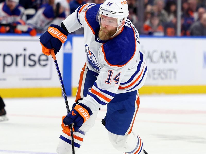 Mar 9, 2024; Buffalo, New York, USA;  Edmonton Oilers defenseman Mattias Ekholm (14) takes a shot on goal during the third period against the Buffalo Sabres at KeyBank Center. Mandatory Credit: Timothy T. Ludwig-USA TODAY Sports