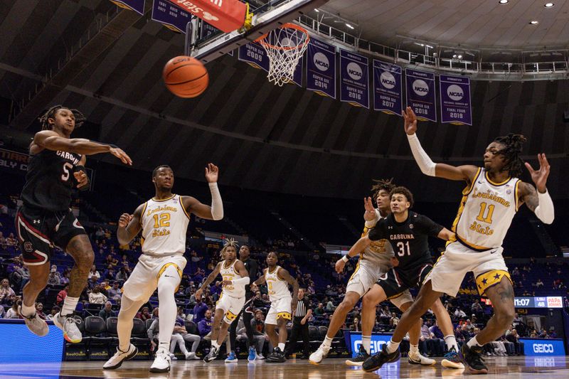 Feb 18, 2023; Baton Rouge, Louisiana, USA; South Carolina Gamecocks guard Meechie Johnson (5) passes there ball around LSU Tigers forward KJ Williams (12) during the second half at Pete Maravich Assembly Center. Mandatory Credit: Stephen Lew-USA TODAY Sports