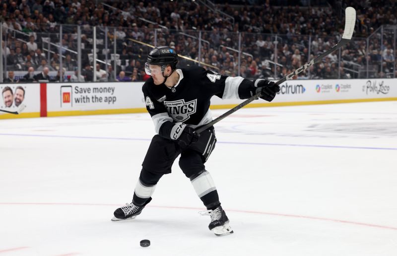 Oct 24, 2024; Los Angeles, California, USA; Los Angeles Kings defenseman Mikey Anderson (44) shoots during the second against the San Jose Sharks period at Crypto.com Arena. Mandatory Credit: Jason Parkhurst-Imagn Images