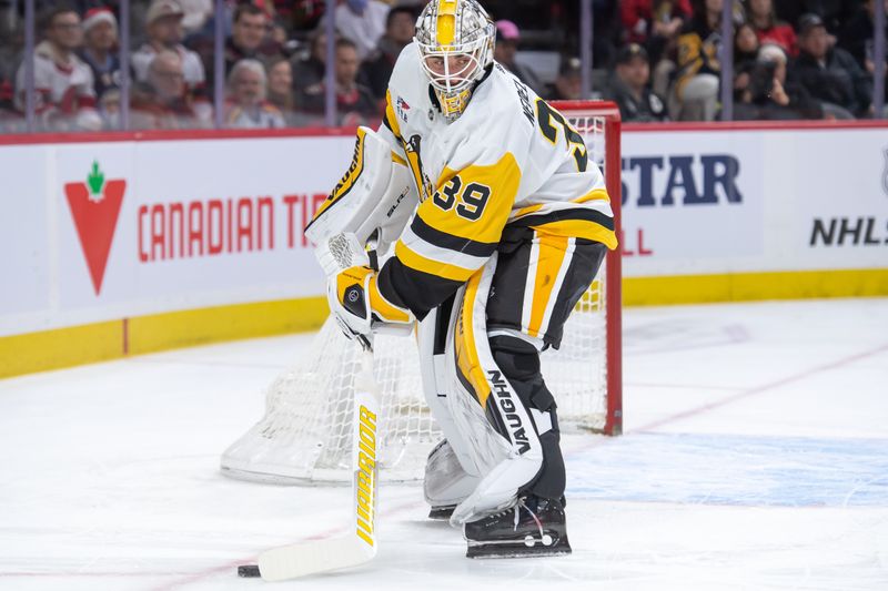 Dec 23, 2023; Ottawa, Ontario, CAN; Pittsburgh Penguins goalie Alex Nedeljkovic (39) moves the puck in the first period against the Ottawa iSenators at the Canadian Tire Centre. Mandatory Credit: Marc DesRosiers-USA TODAY Sports