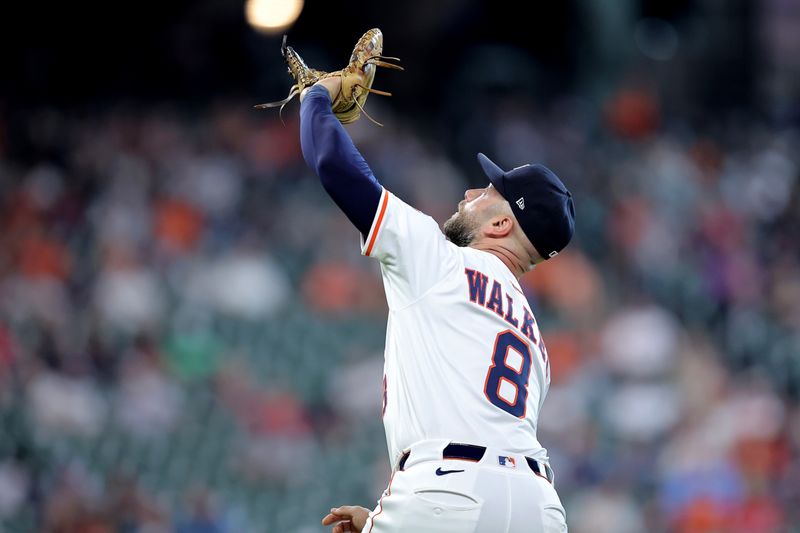 Apr 30, 2025; Houston, Texas, USA; Houston Astros first baseman Christian Walker (8) reaches up to catch a fly ball for an out against the Detroit Tigers during the seventh inning at Daikin Park. Mandatory Credit: Erik Williams-Imagn Images
