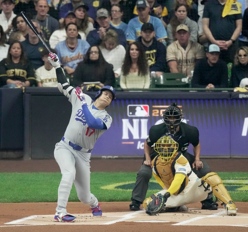 Oct 14, 2025; Milwaukee, Wisconsin, USA; Los Angeles Dodgers designated hitter Shohei Ohtani (17) strikes out against the Milwaukee Brewers in the first inning during game two of the NLCS round for the 2025 MLB playoffs at American Family Field. Mandatory Credit: Mark Hoffman-USA TODAY Network via Imagn Images