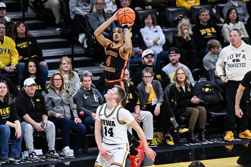 Jan 28, 2026; Iowa City, Iowa, USA; Southern California Trojans forward Chad Baker-Mazara (4) shoots the ball over Iowa Hawkeyes guard Bennett Stirtz (14) during the first half at Carver-Hawkeye Arena. Mandatory Credit: Jeffrey Becker-Imagn Images