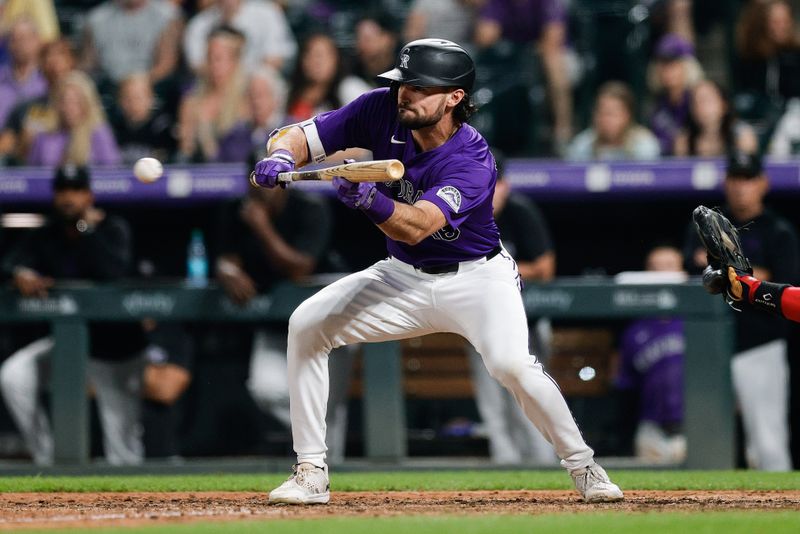 Jul 22, 2024; Denver, Colorado, USA; Colorado Rockies left fielder Sam Hilliard (16) bunts in the twelfth inning against the Boston Red Sox at Coors Field. Mandatory Credit: Isaiah J. Downing-USA TODAY Sports