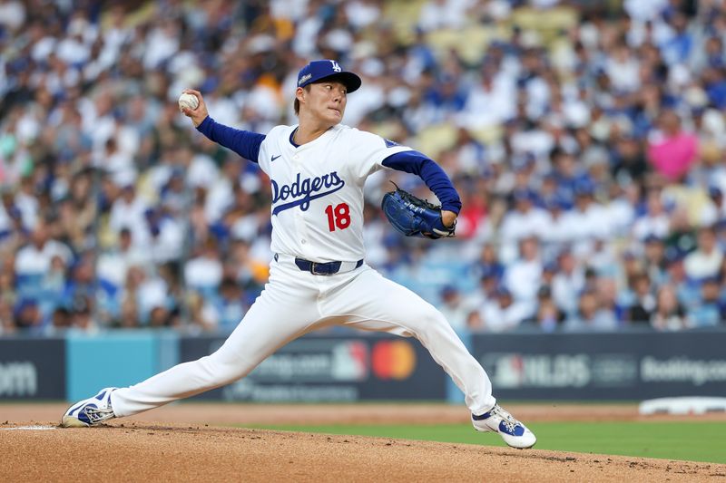 Oct 5, 2024; Los Angeles, California, USA; Los Angeles pitcher Yoshinobu Yamamoto (18) throws a pitch in the first inning against the San Diego Padres during game one of the NLDS for the 2024 MLB Playoffs at Dodger Stadium. Mandatory Credit: Kiyoshi Mio-Imagn Images