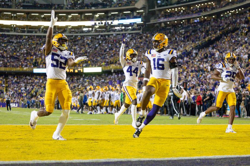 Nov 11, 2023; Baton Rouge, Louisiana, USA;  LSU Tigers cornerback Jeremiah Hughes (29) and linebacker Princeton Malbrue (52) and defensive end Da'Shawn Womack (16) react to a play against the Florida Gators during the second half at Tiger Stadium. Mandatory Credit: Stephen Lew-USA TODAY Sports