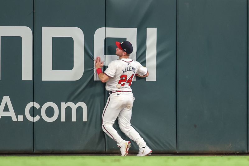 Aug 6, 2024; Atlanta, Georgia, USA; Atlanta Braves center fielder Jarred Kelenic (24) makes a play at the wall against the Milwaukee Brewers in the eighth inning at Truist Park. Mandatory Credit: Brett Davis-USA TODAY Sports
