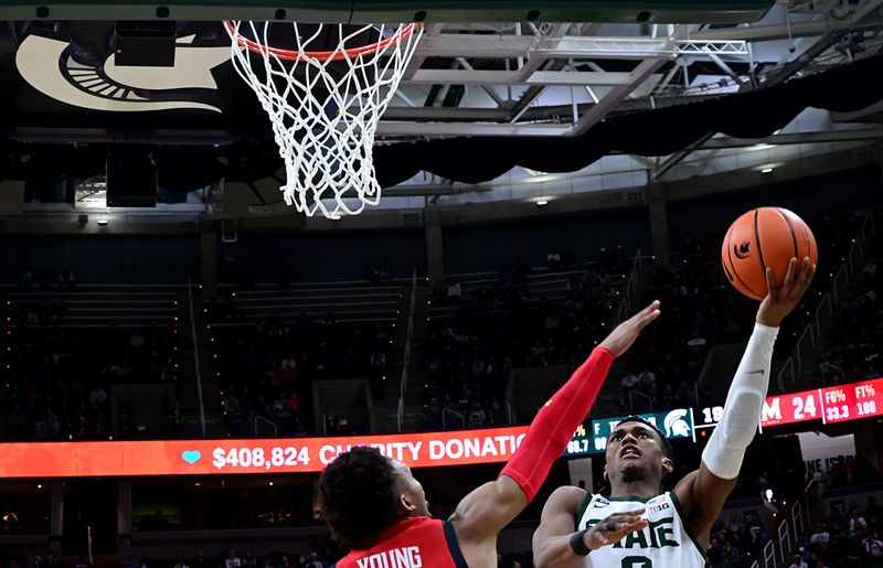 Feb 7, 2023; East Lansing, Michigan, USA;  Michigan State Spartans guard Tyson Walker (2) drives to the basket against Maryland Terrapins guard Jahmir Young (1) in the second half at Jack Breslin Student Events Center. Mandatory Credit: Dale Young-USA TODAY Sports