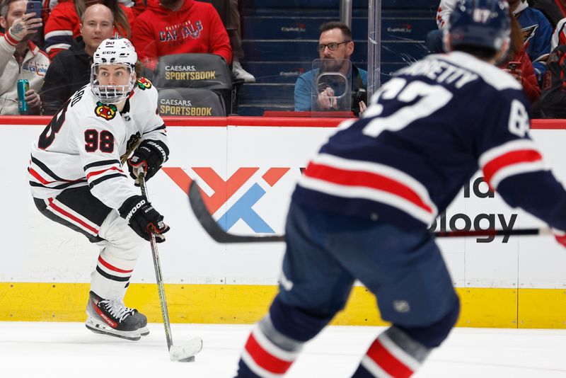 Mar 9, 2024; Washington, District of Columbia, USA; Chicago Blackhawks center Connor Bedard (98) skates with the puck as Washington Capitals left wing Max Pacioretty (67) chases in the second period at Capital One Arena. Mandatory Credit: Geoff Burke-USA TODAY Sports