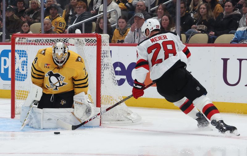 Jan 8, 2026; Pittsburgh, Pennsylvania, USA;  Pittsburgh Penguins goaltender Stuart Skinner (74) makes a save against New Jersey Devils right wing Timo Meier (28) during the second period at PPG Paints Arena. Mandatory Credit: Charles LeClaire-Imagn Images